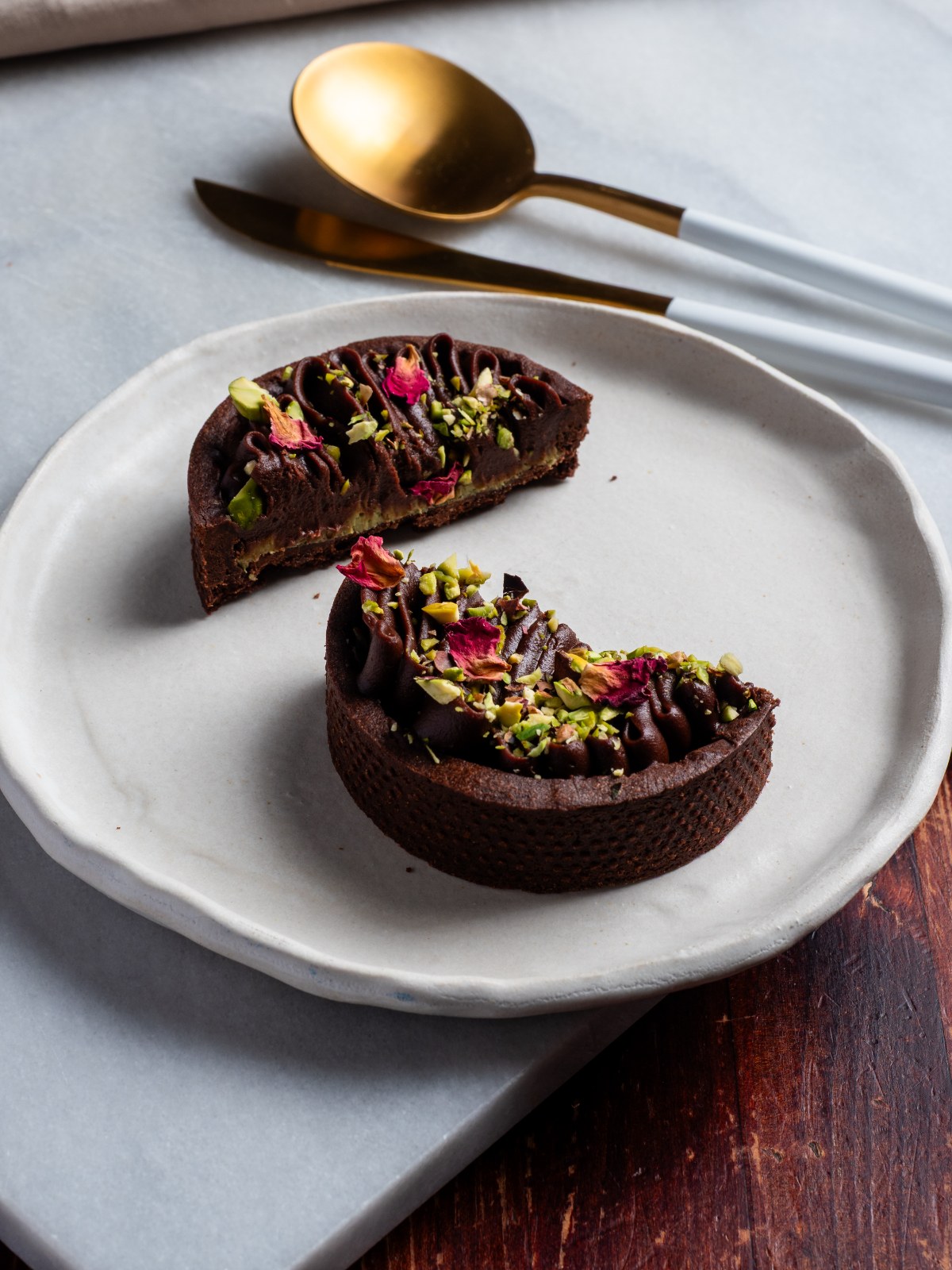 Chocolate tart with pistachio and rose